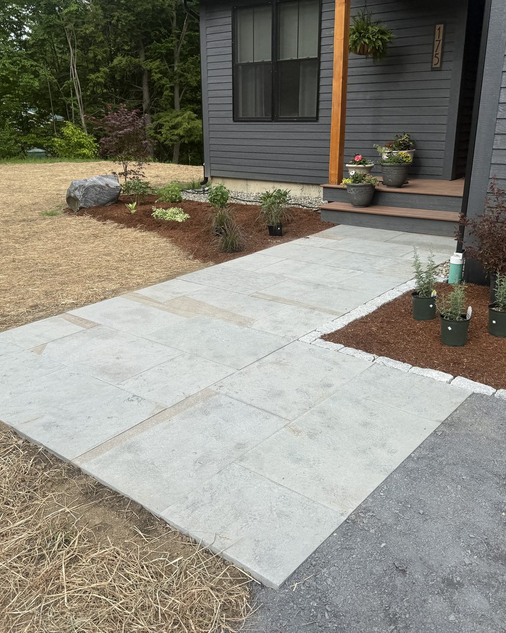 Finished bluestone walkway leading to a modern Vermont home