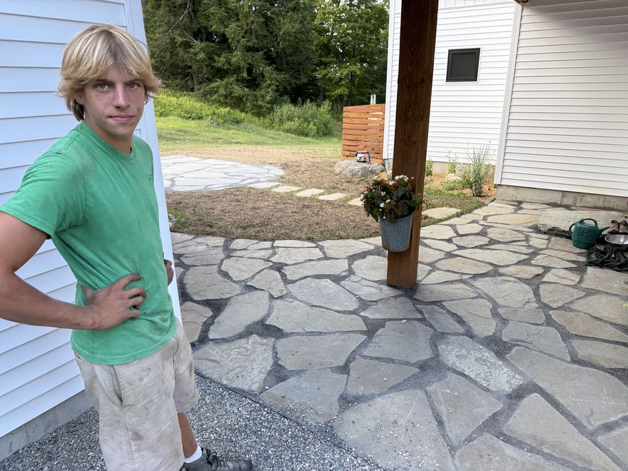 Flagstone patio beside a Vermont home