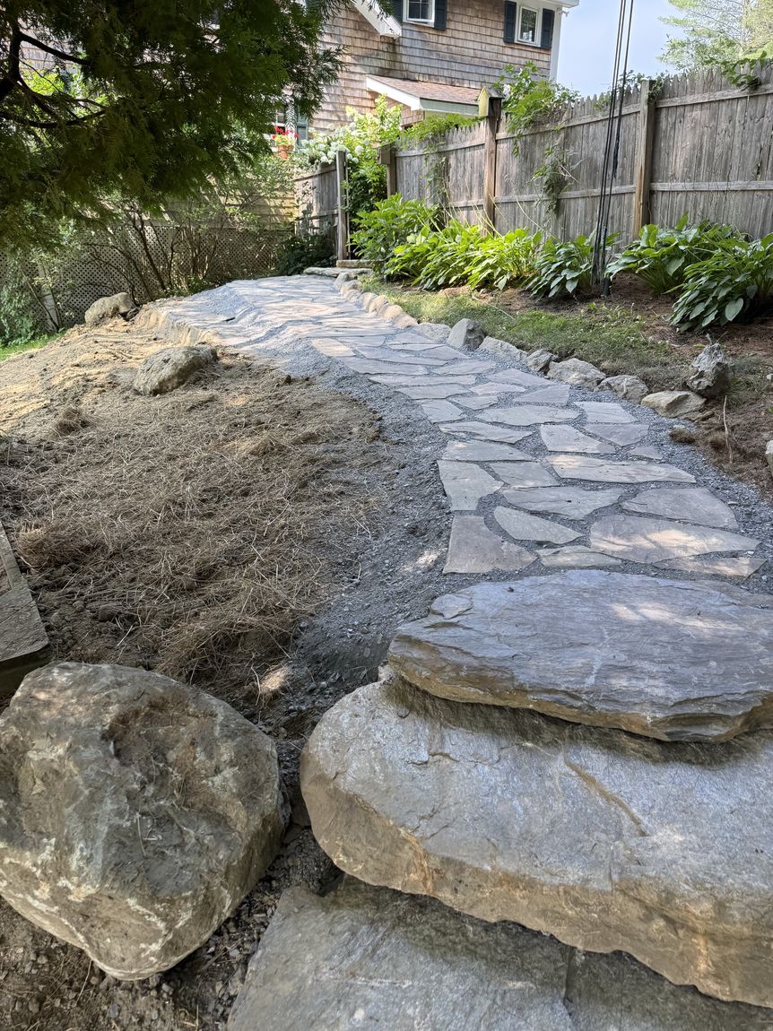 Boulder retaining wall with stone steps