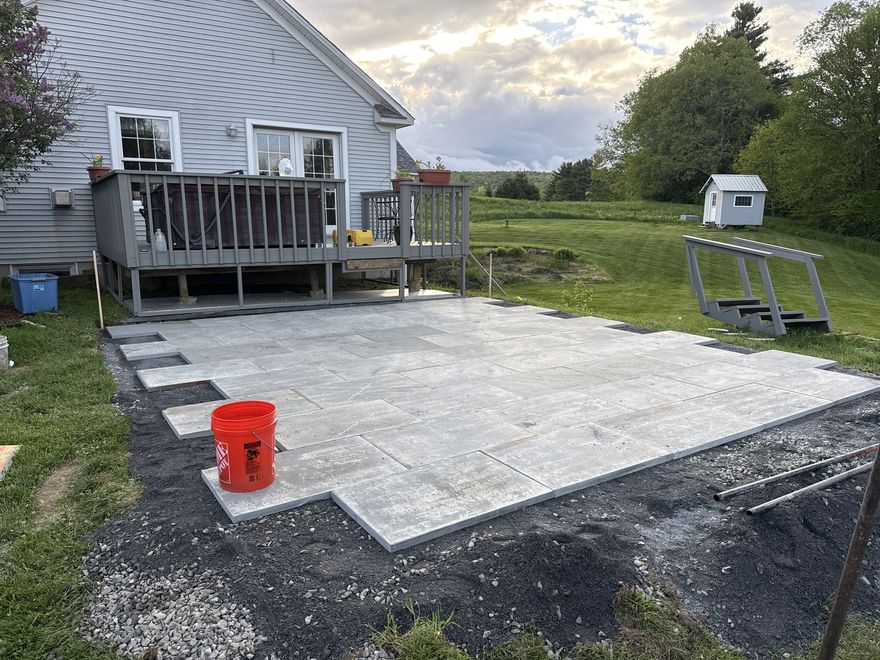 Large bluestone patio behind a Vermont home with mountain view